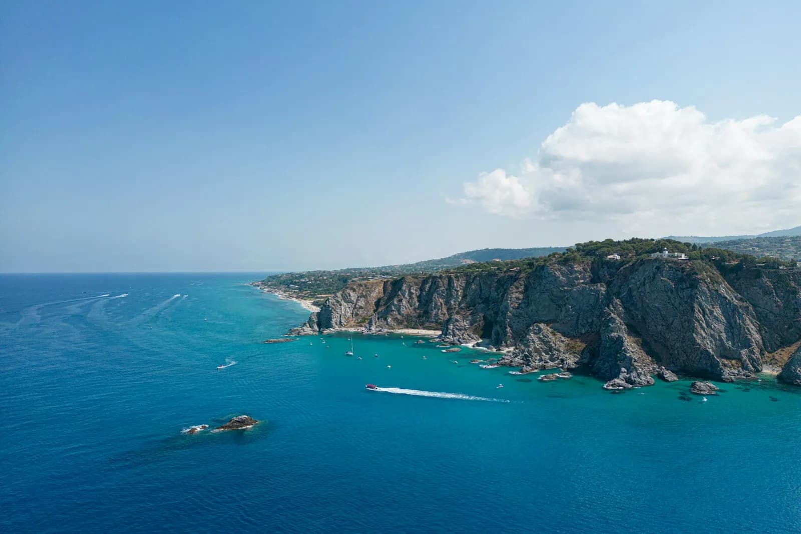 Una cala rocciosa dal mare turchese sulla Costa degli Dei, in Calabria
