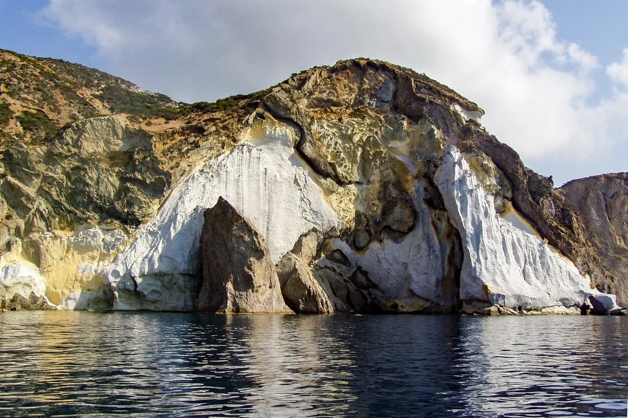 Alta falesia bianca di tufo a picco sul mare a Ponza con grotta marina