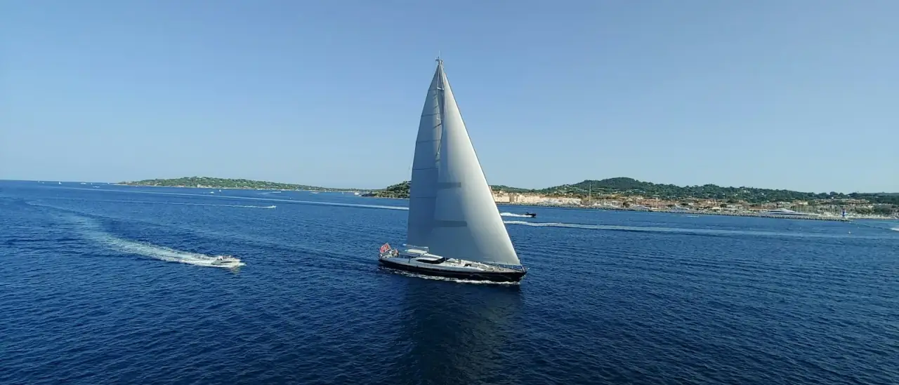 Una barca a vela in navigazione al largo con le vele spiegate nel mare del Mediterraneo