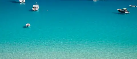 Barche all'ancora nelle acque turchesi di Cala Rossa, Favignana, isole Egadi